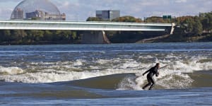 Surfing the river rapids in Montreal,Canada