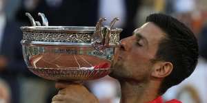 Serbian Novak Djokovic gets his hands – and his lips – on the trophy.