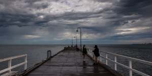 Storm clouds gather over Port Philip Bay at St Kilda ahead of heavy rain.