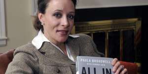 Biographer ... Paula Broadwell poses with her book about David Petraeus.