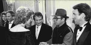 Princess Diana meets one of her favourite performers Elton John (with Robin Williams looking on).
