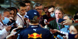 Dutch driver Max Verstappen (back to camera) talks to the media after the Bahrain F1 Grand Prix.