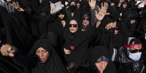 Iranian pro-government demonstrators attend a rally after their Friday prayers to condemn recent anti-government protests