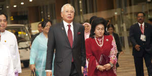Malaysia’s then-PM Najib Razak walks alongside his wife Rosmah Mansor in 2014.