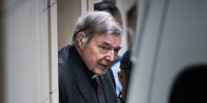 George Pell leaves Melbourne's Supreme Court building in handcuffs on Wednesday.