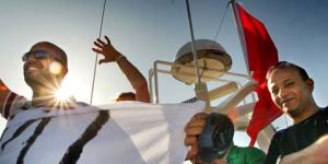 Activists on the Amal passenger boat wave farewell as they set sail from Aghios Nikolaos in Crete,Greece,to join the Free Gaza flotilla.
