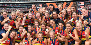 The Crows celebrate with the premiership cup.