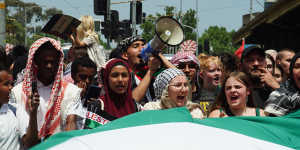 A crowd of students unfurled a watermelon flag in the Palestinian colours of red,white,black and green. 