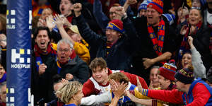 Kai Lohmann of the Lions celebrates a goal with fans.