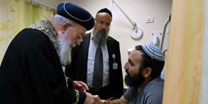 Rabbi Shachar Butzchak (right) is visited by Chief Rabbi of Jerusalem Shlomo Amar.