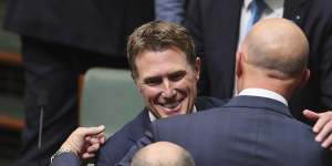Former attorney-general Christian Porter hugs Defence Minister Peter Dutton following his valedictory speech.