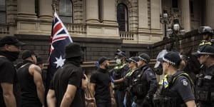 Members of a neo-Nazi group square off against police at an anti-trans rights rally outside Victoria’s parliament in March.