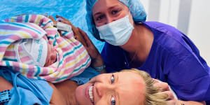 Baby Angus,his intended mother Edwina Peach,and his surrogate mother Jennifer McCloy moments after Angus’ birth in November 2022. The two women are campaigning for change to make surrogacy more accessible in Australia.
