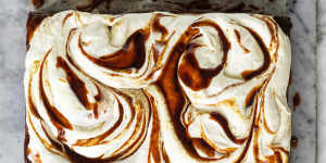 A slab of banana cake with cream cheese icing and swirls of optional miso caramel.