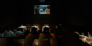 A projector beams mid-century Italian films onto the bar’s walls.