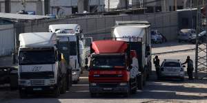Trucks carrying humanitarian aid enter the Gaza Strip via the Rafah crossing with Egypt.