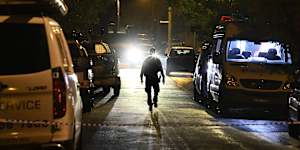 A police officer walks down the Campbelltown street on Monday night.