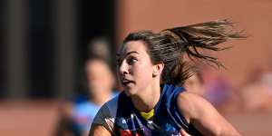 Adelaide’s Niamh Kelly navigates her way through traffic against brisbane.