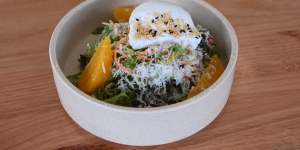 Soba salad topped with a poached egg.