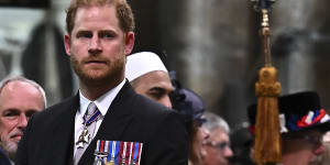 Prince Harry,Duke of Sussex,looks on as his father,King Charles III,leaves Westminster Abbey after the coronation.