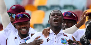 Shamar Joseph celebrates a remarkable Test victory with teammates at the Gabba.