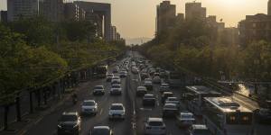 Traffic travel along a road in Beijing. The Chinese economy will grow by less than 2 per cent in 2020 as the anti-virus shutdowns combine with a collapse in global demand due to the pandemic,according to Bloomberg.