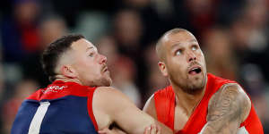 Steven May of the Demons and Sydney’s Lance Franklin square up on Friday night.