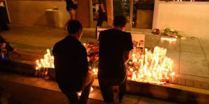 Two men kneel at a makeshift memorial after a killing rampage in Isla Vista near Santa Barbara.