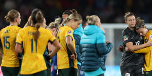 Australia players look dejected after the team’s 1-3 defeat and elimination from the tournament.