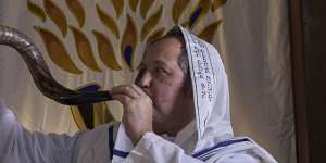 Rabbi Paul Lewin blows the shofar at the North Shore Synagogue in Lindfield.