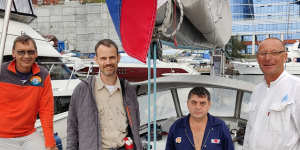 Canadian father Colin Rowat (second from left) sailed from Vladivostok to Fukuoka to see his children in Japan.
