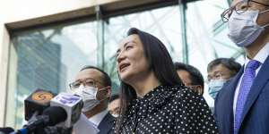 “Over the last three years my life has been turned upside down”:Meng Wanzhou reads a statement outside the court in Vancouver. 