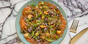 Salmon carpaccio with caper flowers.