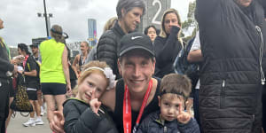 Horse trainer Mitchell Freedman with children Meg and George after the Melbourne Marathon.