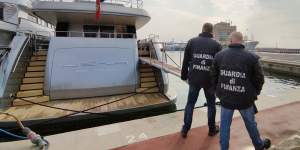Italian Financial Police officers walk by the superyacht Lena,belonging to Gennady Timchenko,an oligarch close to Russian President Vladimir Putin,in the port of San Remo,Italy,on Saturday,March 5,2022. 