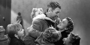 James Stewart sees the beauty that surrounds him and the townsfolk break into Auld Lang Syne in It’s a Wonderful Life.