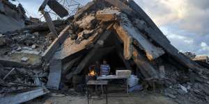 A man sells bread under the rubble of his bakery destroyed by the Israeli air and ground offensive in Jabaliya,Gaza Strip.