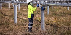 A worker checks newly constructed metal frames for photovoltaic solar farm. Many people think markets should dictate where