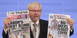 Former prime minister Kevin Rudd holds up the Daily Telegraph during his address to the National Press Club of Australia in March 2021,where he railed against the power of News Corp.