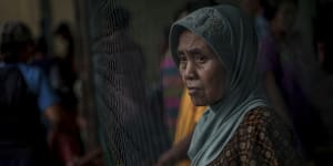 A survivor pauses at a temporary shelter for those affected by Saturday's tsunami in Carita,Indonesia.
