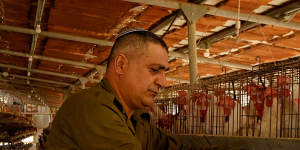 Chicken farmer and emergency squad member Yonatan Yaakobi at his farm in Margaliot.