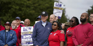 Joe Biden stands with striking car workers.