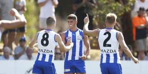 New Roo Harry Sheezel (centre) made an impact for North Melbourne against Richmond.