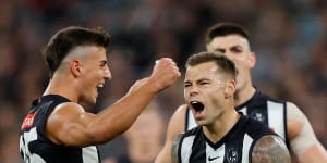 Jamie Elliott celebrates a goal with Magpies teammate Nick Daicos.