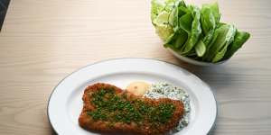 The veal schnitzel is served with two sauces:gribiche and mustard.