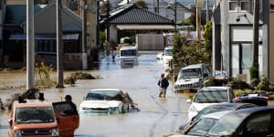 Japan typhoon death toll climbs,while floodwaters recede