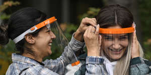 Students try out face shields to fight the coronavirus pandemic at a school in Cologne,Germany.