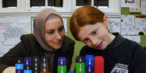 Canterbury Public School teacher Rama Matar with year 3 student Anouk Jago during a lesson on fractions. 