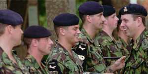 Prince Andrew,right,talks with members of the 1st Battalion the Staffordshire Regiment,stationed in Hong Kong with the British military forces. in 1996.