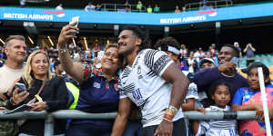 Fiji’s Selestino Ravutaumada poses with fans after the England win.